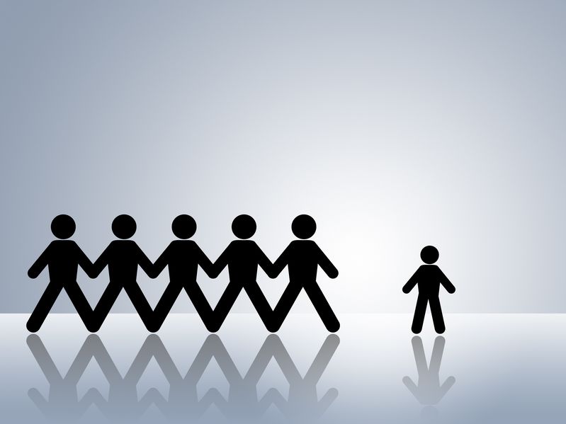Silhouette of a person with dwarfism standing next to a group of people of average height